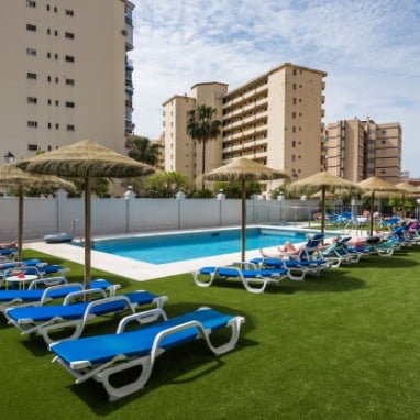 Solarium area next to the swimming pool of Veramar Aparthotel